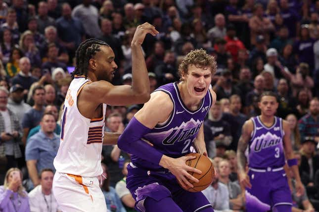 Nov 17, 2023; Salt Lake City, Utah, USA; Utah Jazz forward Lauri Markkanen (23) goes to the basket against Phoenix Suns forward Keita Bates-Diop (21) in the fourth quarter at Delta Center.