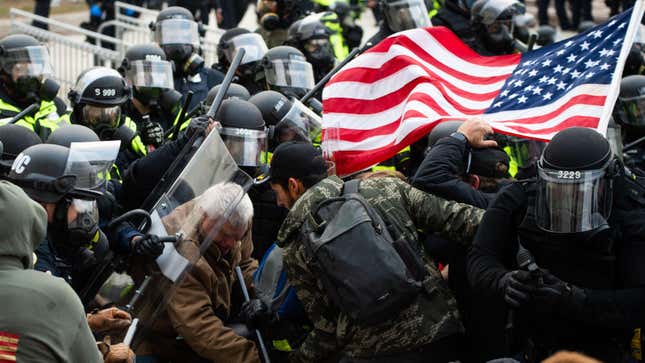 Supporters of US President Donald Trump fight with riot police outside the Capitol building on January 6, 2021 in Washington, DC.