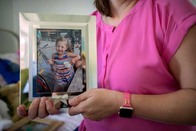 Jessica Riester Hart holds a photo of her daughter, 5-year-old Allie Hart, who was struck and killed in 2021 by a driver while riding her bicycle in a crosswalk near their home, Thursday, Sept. 14, 2023, in Washington. (AP Photo/Mark Schiefelbein)