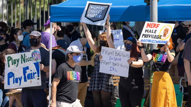 Activision Blizzard employees protest outside the Blizzard offices, holding signs like "Women's Voices Matter!" and "Nerf Male Privilege".