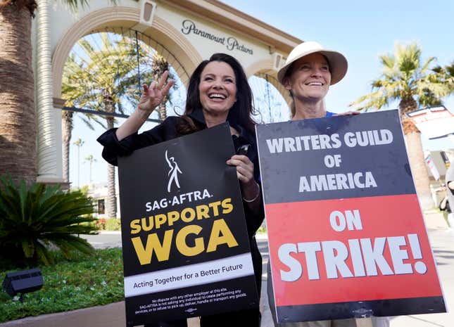 FILE - Fran Drescher, left, president of SAG-AFTRA, and Meredith Stiehm, president of Writers Guild of America West, pose together during a rally by striking writers outside Paramount Pictures studio in Los Angeles on May 8, 2023. (AP Photo/Chris Pizzello, File)