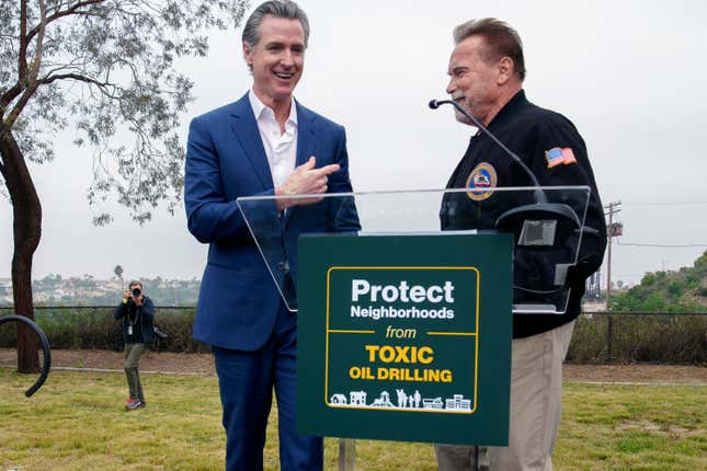 California Gov. Gavin Newsom, left, joins former California Gov. Arnold Schwarzenegger during a news conference for the Campaign for a Safe and Healthy California campaign for Keep The Law (SB 1137) in Inglewood, Calif., on Friday, March. 22, 2024. The law, if upheld, would require all oil or gas production facilities or wells within a health protection zone to comply with new regulations. (AP Photo/Damian Dovarganes)