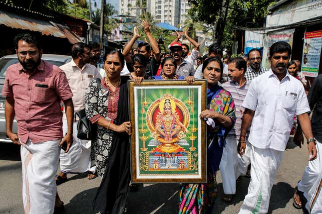 Protesters hold a portrait of lord Ayyappa on Jan. 02.
