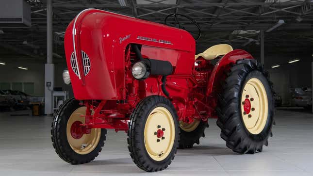 A photo of a red Porsche Tractor from the 1950s. 