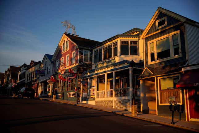 File - Early-morning light shines on shops on Main Street, June 11, 2022, in Bar Harbor, Maine. Small businesses face a mix of old and new challenges as 2023 begins. Regulations are a double-edged sword. They’re created to improve business dealings, discourage unfair or illegal business activity, and protect workers. But, for small business owners, they often mean more red tape, higher costs and possible penalties for failing to comply. (AP Photo/Robert F. Bukaty, File)