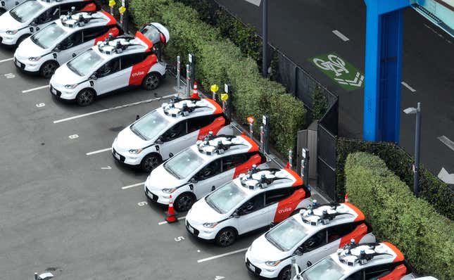 In an aerial view, Chevrolet Cruise autonomous vehicles sit parked in a staging area on June 08, 2023 in San Francisco, California. 