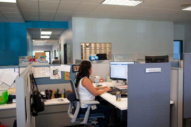 File - Social worker Lupita Armijo-Garcia works at her desk in the Ottawa County, Mich., Department of Public Health office, Tuesday, Sept. 5, 2023, in Holland, Mich. On Friday, the U.S. government issues its November jobs report. (AP Photo/Kristen Norman, File)