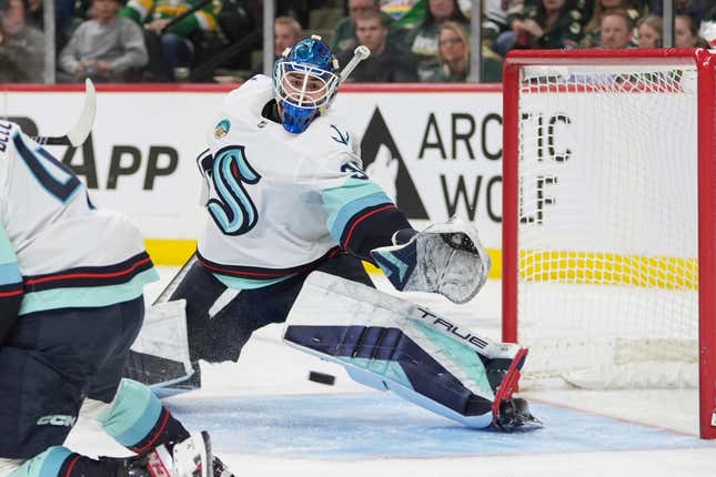 Seattle Kraken goaltender Joey Daccord defends against a Minnesota Wild shot during the third period of an NHL hockey game Thursday, April 18, 2024, in St. Paul, Minn. (AP Photo/Abbie Parr)