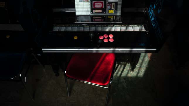 A seat is pulled out in front of an arcade cabinet at Mikado in Tokyo, Japan. 