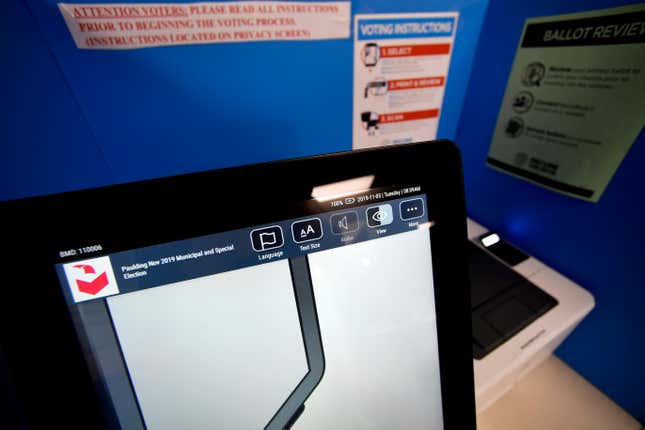 In this Tuesday, Nov. 5, 2019 photo, a touchscreen voting machine and printer are seen in a voting booth, in Paulding, Ga. Election integrity activists want a federal judge to order Georgia to stop using its current election system, saying it&#39;s vulnerable to attack and has operational issues that could cost voters their right to cast a vote and have it accurately counted.(AP Photo/Mike Stewart)