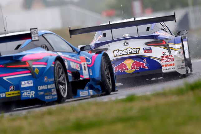 Cars on track at a Super GT race at the Suzuka Circuit from 2018.