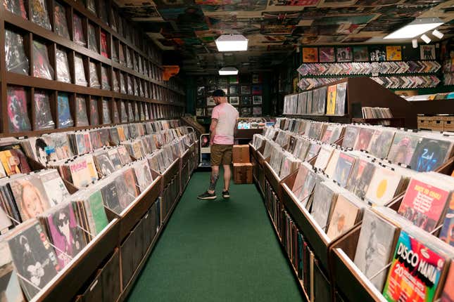 Jeff Maimon, of Chicago, checks out some vinyl at Tracks In Wax record shop, Thursday, April 18, 2024, in Phoenix. Special LP releases, live performances and at least one giant block party are scheduled around the U.S. Saturday as hundreds of shops celebrate Record Store Day amid a surge of interest in vinyl and the day after the release of Taylor Swift&#39;s latest album. (AP Photo/Ross D. Franklin)