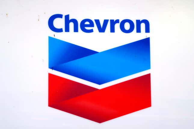 A Chevron logo rides atop a gas station in Columbus, Miss., Monday, Oct. 23, 2023. Chevron is buying the Hess Corp. for $53 billion which adds a major oil field in Guyana as well as shale fields in North Dakota. (AP Photo/Rogelio V. Solis)