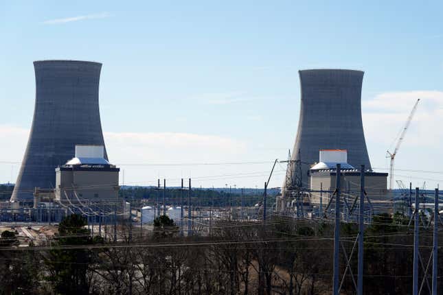 FILE - Units 3, left, and 4 and their cooling towers stand at Georgia Power Co.&#39;s Plant Vogtle nuclear power plant, Jan. 20, 2023, in Waynesboro, Ga. Georgia&#39;s Public Service Commission voted 5-0 on Tuesday, Dec. 19, 2023 to approve a 6% rate increase for remaining costs that will take effect once Unit 4 begins commercial operation. (AP Photo/John Bazemore, File)