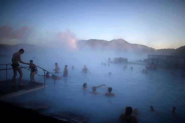 People relax in a hot spring near the town of Grindavik, Iceland.