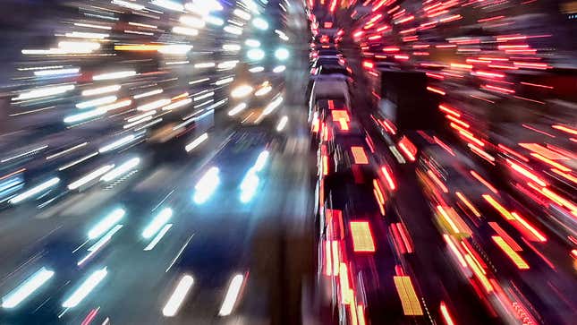 A photo of the headlights and tail lights of cars on a highway. 