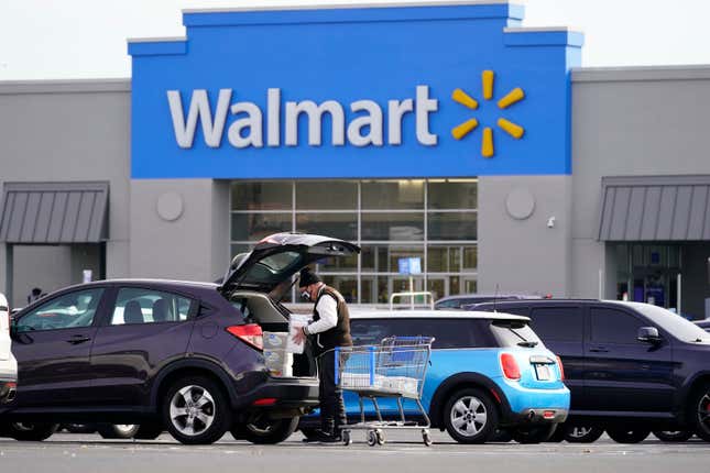 FILE - A customer loads a car after shopping at a Walmart in Philadelphia, Nov. 17, 2021. Walmart, the nation&#39;s largest private employer, is expanding nationwide its health care coverage next month for employees who want to enlist the services of a doula, a person trained to assist women during pregnancies. (AP Photo/Matt Rourke, file)