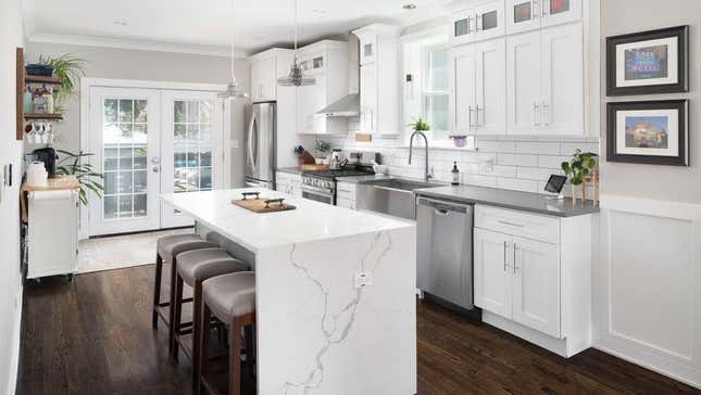 Kitchen with waterfall granite countertops whose stone takes a right angle and extends all the way to the floor