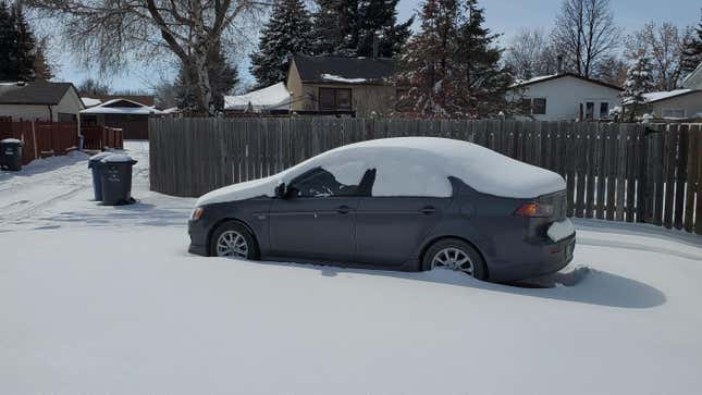 Photo of a Mitsubishi Lancer covered in snow