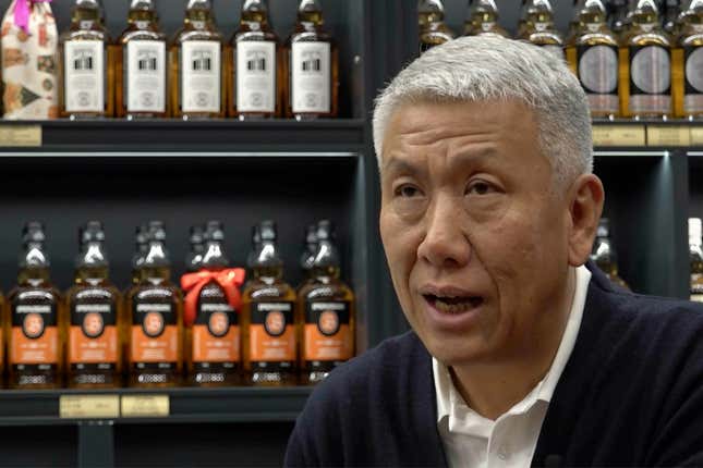 In this image from a video, Raymond Lee, founder of Single Malt Club China, at right, speaks at a whisky store in Beijing on Dec. 9, 2023. Raymond Lee, founder of the Single Malt Club China, a whisky trading and distribution company established in Beijing in 2005, said whisky has become more popular as the economy has grown. (AP Photo/Caroline Chen)