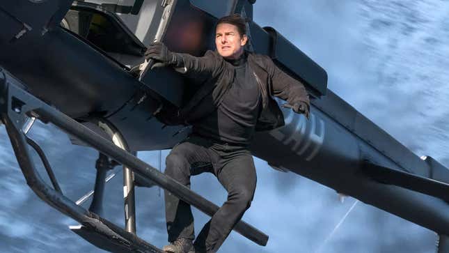 Tom Cruise rides on the side of a helicopter in Mission: Impossible—Fallout.