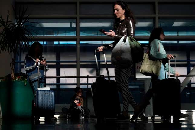 FILE - Commercial airline passengers wait, and make their way through the ticketing level at Chicago&#39;s Midway International Airport Friday, May 26, 2023, in Chicago. U.S. airfares are, on average, 15% lower now than they were a decade ago, and 6% lower than this time last year. The same cannot be said for many other purchasing categories where prices are increasing due to inflation. (AP Photo/Charles Rex Arbogast, File)