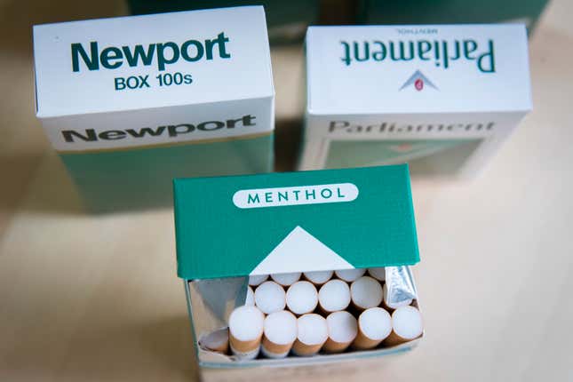 Boxes of menthol versions of Newport and Parliament cigarettes. One box is open, displaying rows of cigarettes.