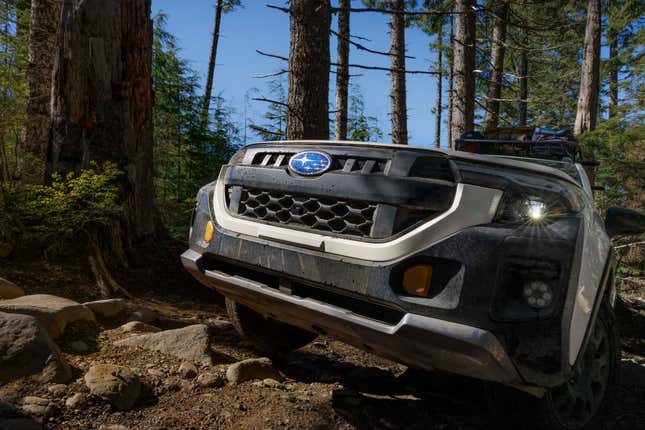 a close-up of the nose of the new forester wilderness driving on a trail in a forest