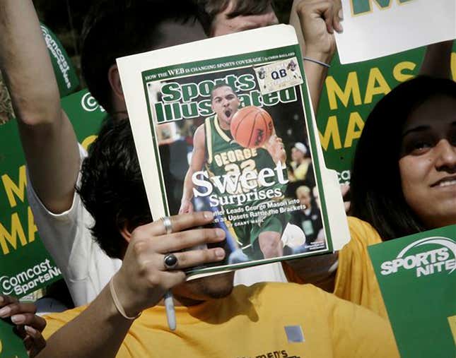 FILE - A George Mason University fan holds up a Sports Illustrated magazine at a send off for the team, March 29, 2006, in Fairfax, Va. Sports Illustrated is the latest media company damaged by being less than forthcoming about who or what is writing its stories. The website Futurism reported that the once-grand magazine used articles with “authors” who apparently don&#39;t exist, with photos generated by AI. The magazine denied claims that some articles themselves were AI-assisted, but has cut ties with a vendor it hired to produce the articles. (AP Photo/Lawrence Jackson, File)