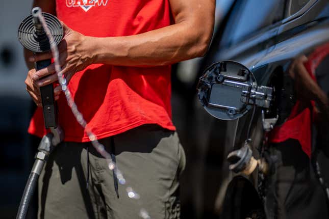  A person pulls the gas pump out of their vehicle at a Shell gas station on August 03, 2023 in Austin, Texas