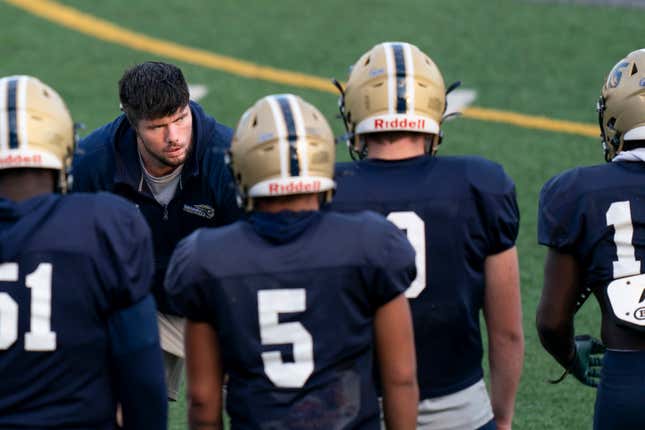 Gallaudet assistant coach Shelby Bean, left, coaches players during football practice at Hotchkiss Field, Tuesday, Oct. 10, 2023, in Washington. As a Deaf football player for four years at Gallaudet, Bean called defensive plays with American Sign Language and dealt with other obstacles hearing opponents would never need to worry about. Now he was on the sideline earlier this month when a new football helmet the school developed with AT&amp;T allowed the plays to be displayed visually inside quarterback Brandon Washington&#39;s helmet. (AP Photo/Stephanie Scarbrough)