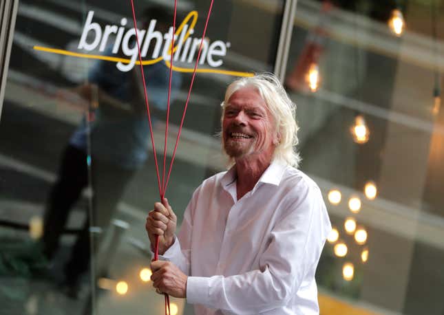 FILE - Richard Branson, of Virgin Group, prepares to unfurl a banner during a naming ceremony for the Brightline train station, to be renamed as Virgin MiamiCentral in Miami on April 4, 2019. A British judge ruled in favor of Richard Branson&#39;s Virgin group on Thursday Oct. 12, 2023 in its lawsuit against a U.S. train company that terminated a licensing agreement and claimed the Virgin brand was no longer one of “high repute.” (AP Photo/Lynne Sladky, File)