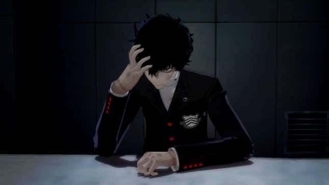 Joker sits bloody and bruised at a table.
