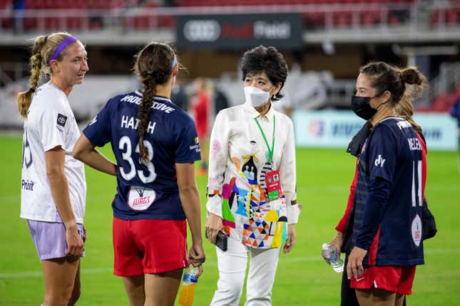 FILE - Washington Spirit co-owner Y. Michelle Kang, third from left, talks to Spirit players after an NWSL soccer match against Racing Louisville FC, Saturday, Oct. 9, 2021, in Washington. Washington Spirit majority owner Michelle Kang has acquired The London City Lionesses soccer team, it was announced Friday, Dec. 15, 2023. (AP Photo/Amanda Andrade-Rhoades, File)