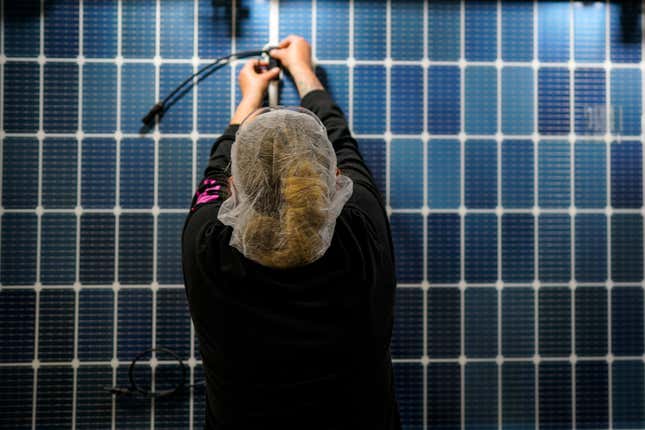 File - An employee works on a solar panel inside the Hanwha Qcells Solar plant on Oct. 16, 2023, in Dalton, Ga. On Wednesday, the Labor Department reports on job openings and labor turnover for September. (AP Photo/Mike Stewart, File)