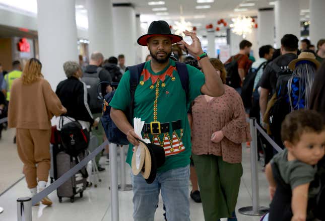 Travelers stand in line for a TSA checkpoint at the Miami International Airport on December 19, 2022 in Miami, Florida. Miami International Airport is expecting a busy winter holiday travel season this year, with 2.5 million passengers expected from December 21 to January 6, for a 1.5% increase over its record-breaking period in 2021.