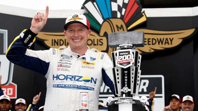 Michael McDowell, driver of the #34 Horizon Hobby Ford, celebrates in victory lane after winning the NASCAR Cup Series Verizon 200 at the Brickyard at Indianapolis Motor Speedway on August 13, 2023 in Indianapolis, Indiana.