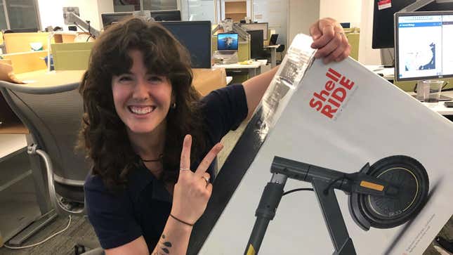 Journalist posing with a shell e-scooter