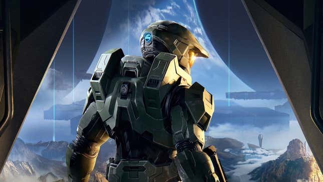 The Master Chief stands with his back toward the camera while looking at the Halo ring's environment. 