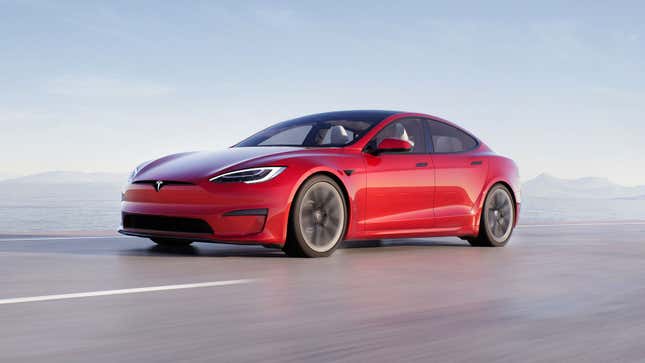 A photo of a red Tesla Model S sedan driving. 