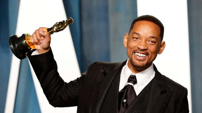 Actor Will Smith holds up his Oscar at the 2022 Academy Awards. 