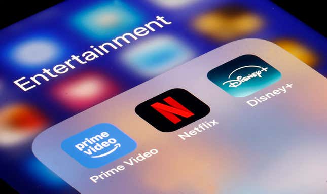 In this photo illustration, Prime video, Netflix media service provider’s logos is displayed on the screen of an iPhone