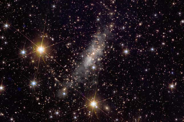Gravitational lensing in the galaxy cluster.