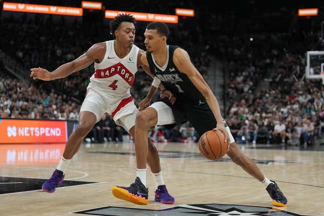 Nov 5, 2023; San Antonio, Texas, USA;  San Antonio Spurs center Victor Wembanyama (1) dribbles against Toronto Raptors forward Scottie Barnes (4) in the second half at the Frost Bank Center.