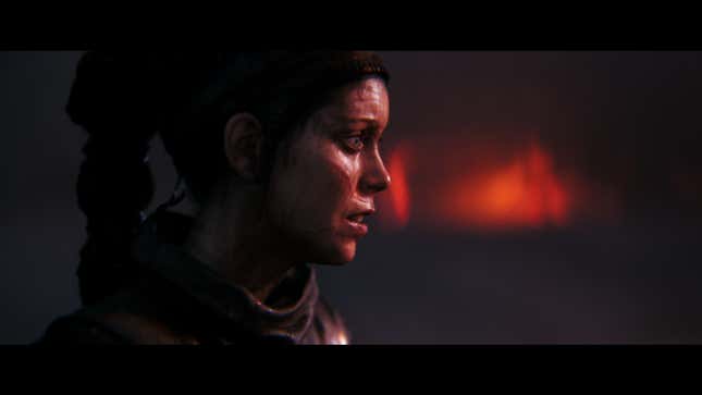 A side shot of Senua shows her face wrought with grief.