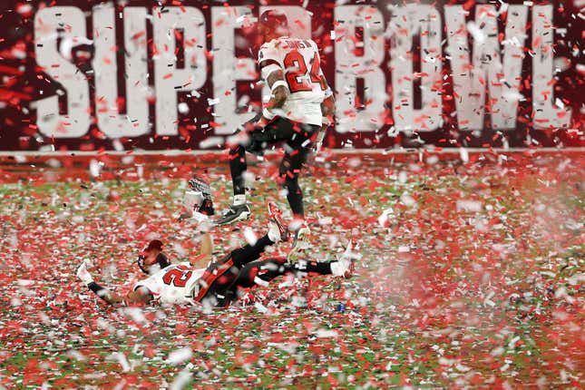 Andrew Adams #26 and Carlton Davis #24 of the Tampa Bay Buccaneers celebrate as confetti falls after defeating the Kansas City Chiefs in Super Bowl LV at Raymond James Stadium on February 07, 2021 in Tampa, Florida. 