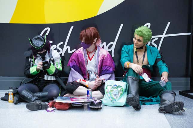 Costumed attendees take a break during Anime NYC at the Jacob K. Javits Convention Center in New York City on November 20, 2021.
