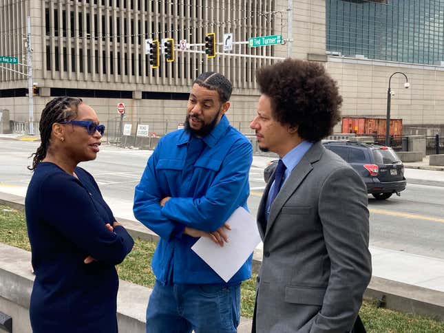 Comedians Clayton English, center, and Eric André, right, speak with their attorney, Allegra Lawrence-Hardy outside the federal courthouse in Atlanta on Tuesday, Oct. 11, 2022. 