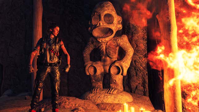 The main character from Far Cry 6 seen standing next to a monkey statue near a big fire in a temple. 