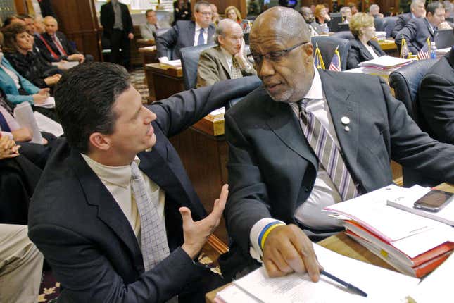 FILE - Rep. Sean Eberhart, R-Shelbyville, left, talks with Rep. Charlie Brown, D-Gary, during a session at the Statehouse in Indianapolis, Feb. 24, 2010. Former Indiana lawmaker Eberhart has agreed to plead guilty to a federal charge alleging that he accepted promises of lucrative employment from a gaming company during his time in public office, federal prosecutors said Friday, Nov. 10, 2023. (AP Photo/Darron Cummings, File)